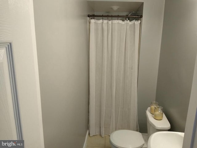 full bath featuring tile patterned flooring and toilet