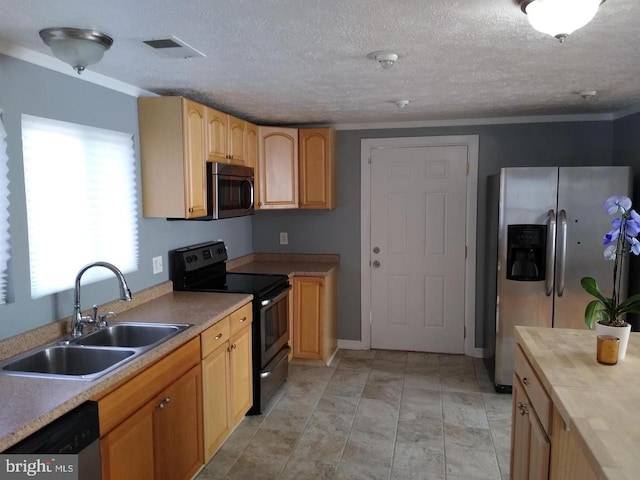 kitchen with visible vents, appliances with stainless steel finishes, light countertops, light brown cabinetry, and a sink