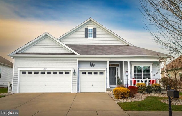 view of front of property featuring concrete driveway, a porch, roof with shingles, and an attached garage