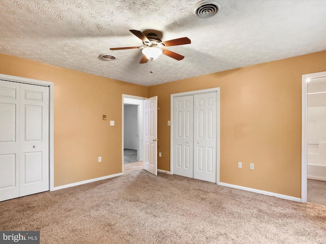 374 Tuscawilla Dr, Charles Town, WV 25414 - unfurnished bedroom with visible vents, two closets, and carpet floors