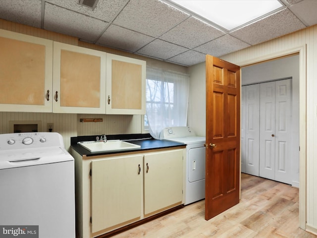 374 Tuscawilla Dr, Charles Town, WV 25414 - laundry room with light wood finished floors, a sink, hookup for a washing machine, and cabinet space