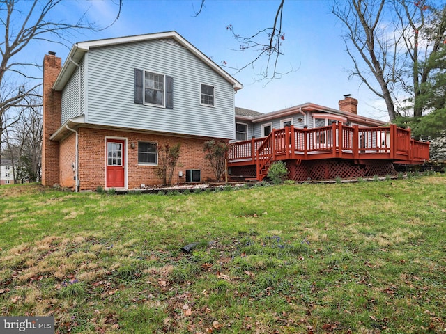 374 Tuscawilla Dr, Charles Town, WV 25414 - back of property featuring brick siding, a deck, a chimney, and a lawn