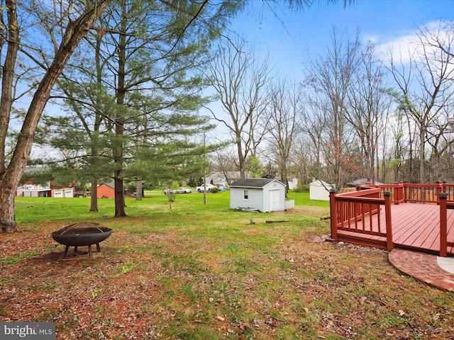 374 Tuscawilla Dr, Charles Town, WV 25414 - view of yard with an outdoor fire pit, an outbuilding, a shed, and a wooden deck