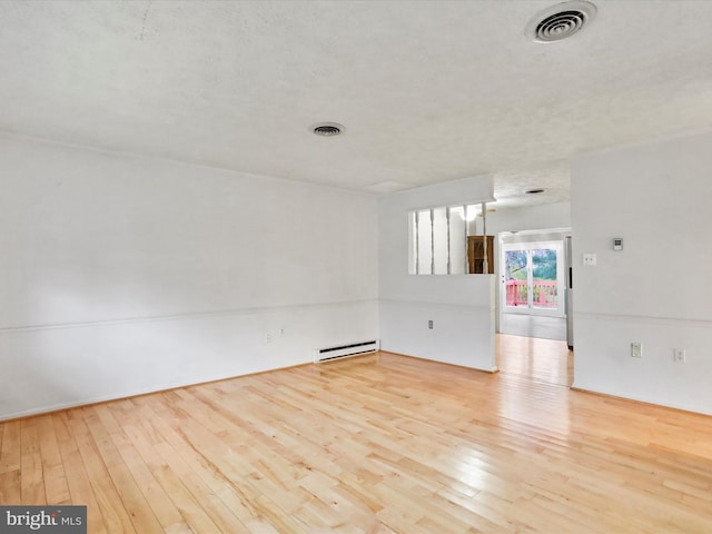 374 Tuscawilla Dr, Charles Town, WV 25414 - empty room with wood-type flooring, baseboard heating, and visible vents