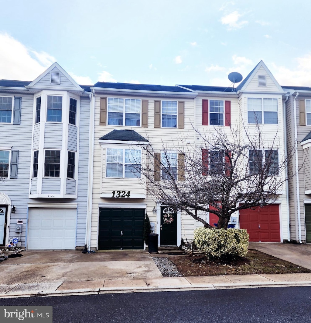 view of property featuring a garage and driveway