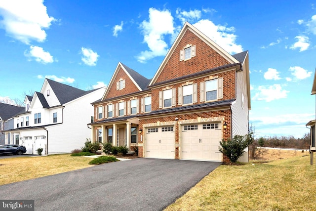 view of front of home with aphalt driveway, a front lawn, brick siding, and an attached garage