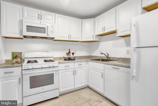 kitchen with white appliances, a sink, white cabinetry, marble finish floor, and light countertops