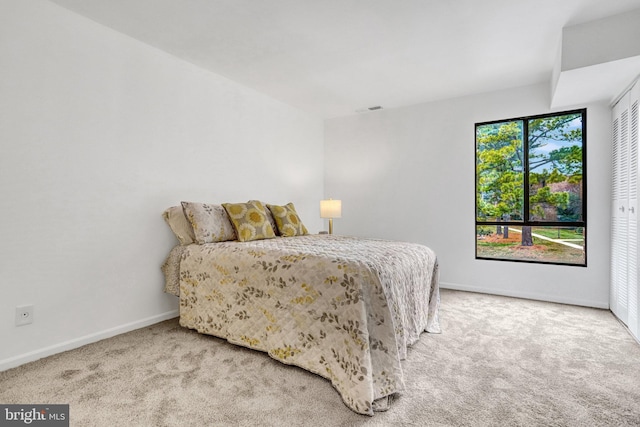 carpeted bedroom with baseboards and visible vents