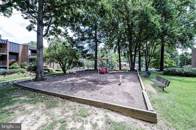 view of home's community with playground community and a yard