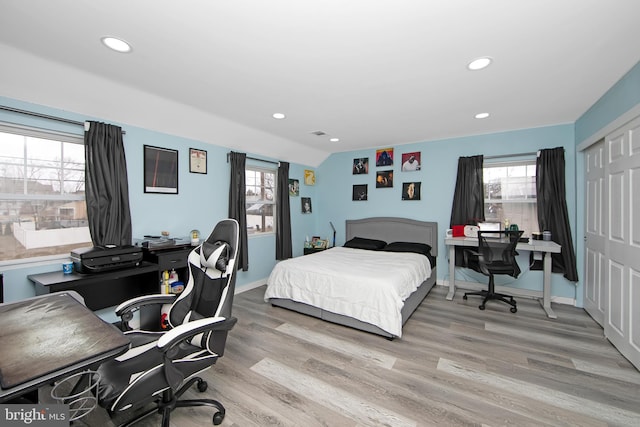 bedroom featuring a closet, light wood-style flooring, and recessed lighting