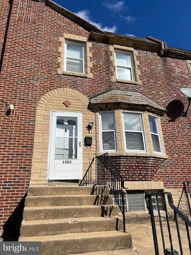 view of front of house with brick siding and entry steps