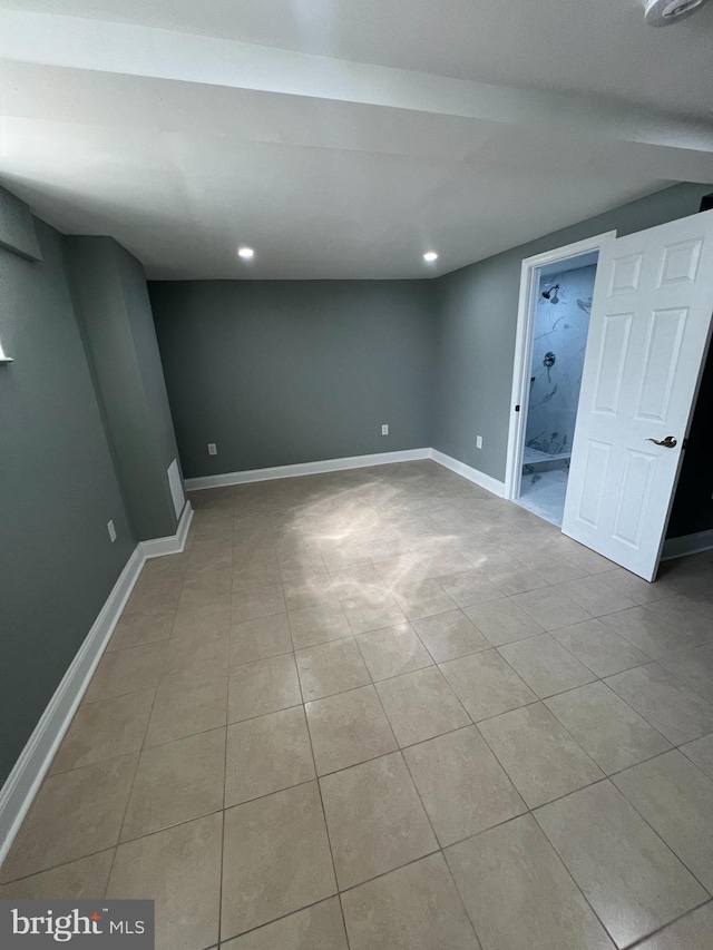 finished below grade area featuring baseboards, light tile patterned floors, and recessed lighting