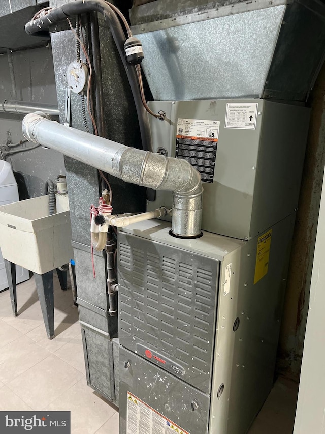 utility room featuring heating unit