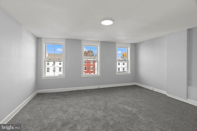 empty room with dark colored carpet