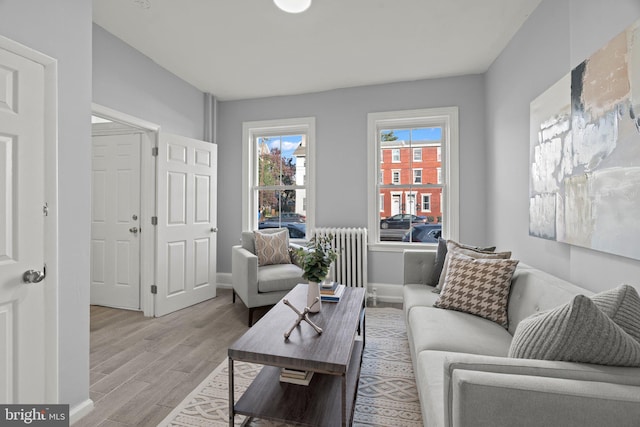 living room with radiator and light hardwood / wood-style floors