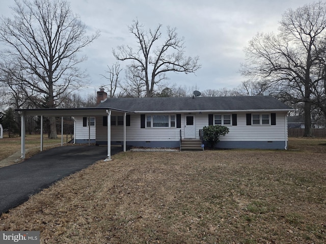 view of front of property with aphalt driveway, crawl space, a chimney, and a carport