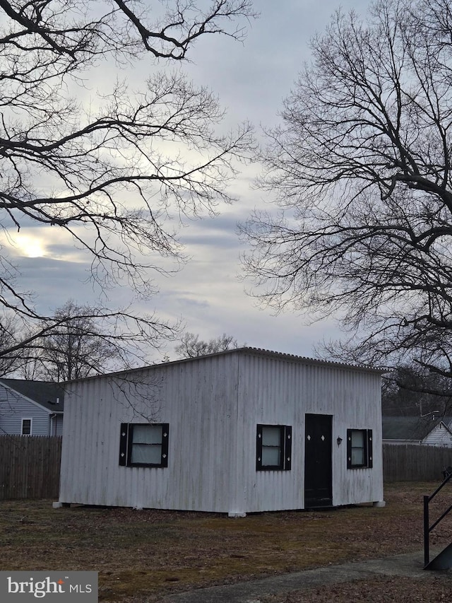 view of outbuilding with fence