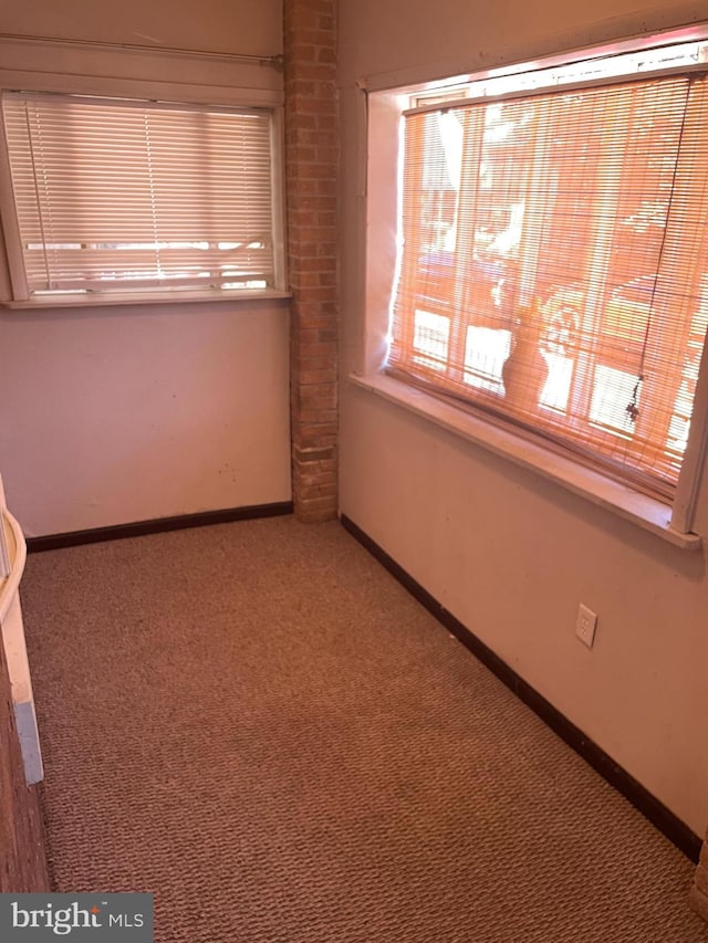 carpeted spare room with baseboards