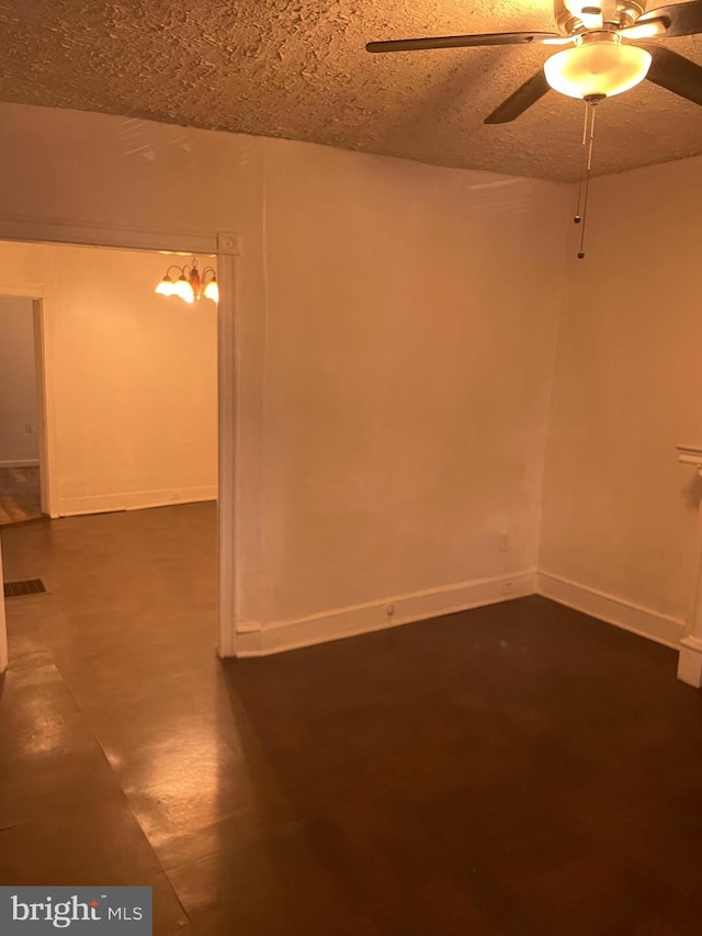 interior space with visible vents, ceiling fan, a textured ceiling, and baseboards