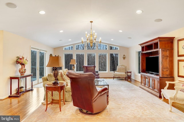 living area with light wood-type flooring, vaulted ceiling, a notable chandelier, and recessed lighting