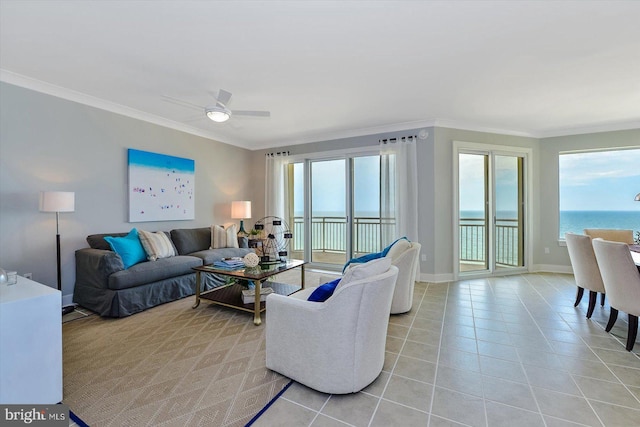 living area with a ceiling fan, a healthy amount of sunlight, crown molding, and light tile patterned floors