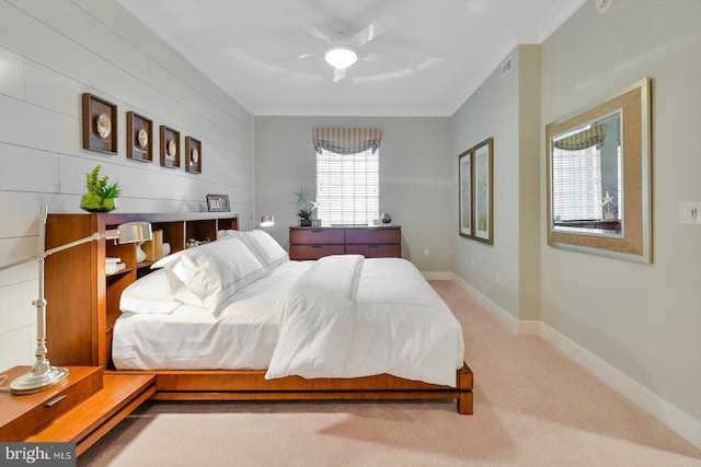 carpeted bedroom featuring crown molding and ceiling fan