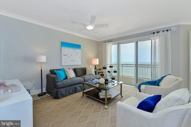 living area with a ceiling fan, crown molding, and baseboards