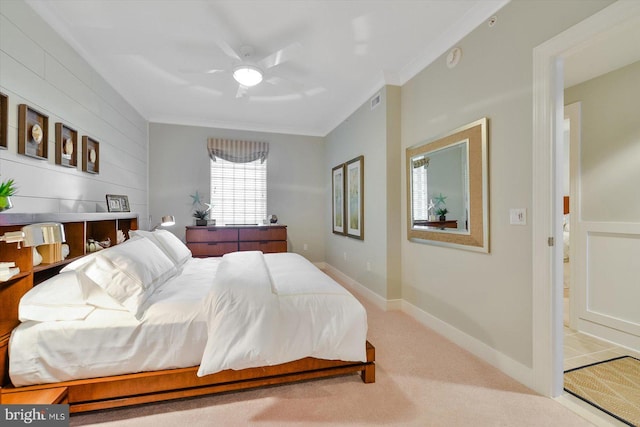 carpeted bedroom featuring crown molding and ceiling fan