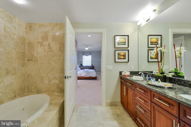 bathroom featuring vanity and tiled bath