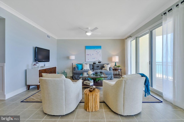 living room with crown molding, light tile patterned flooring, and ceiling fan