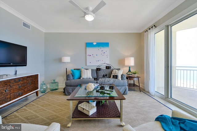 living room featuring ceiling fan and ornamental molding