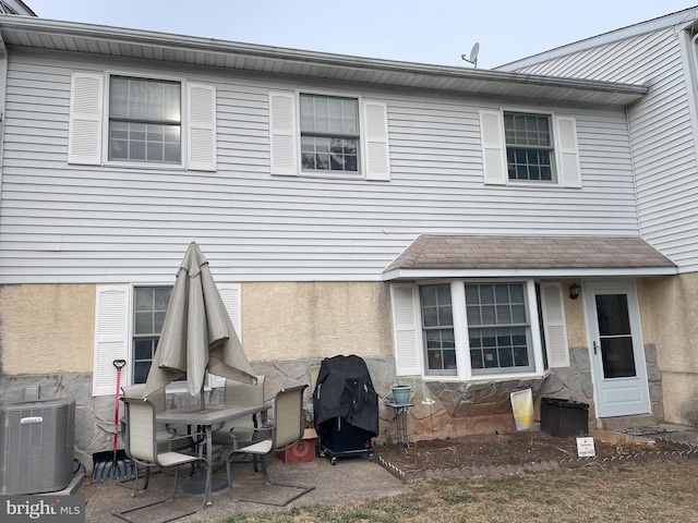 back of house featuring central air condition unit