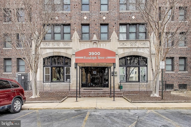 view of building exterior featuring uncovered parking