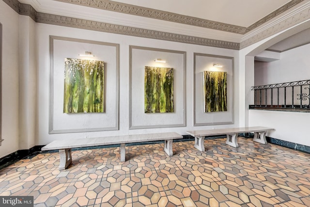 interior space with crown molding and baseboards