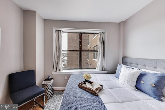 bedroom featuring baseboards and wood finished floors