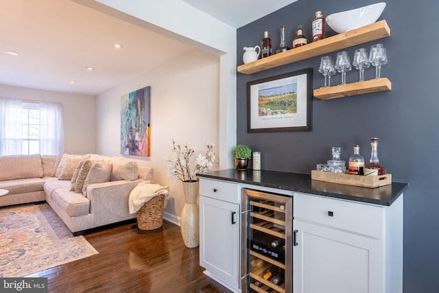 bar with dark wood-style floors, wine cooler, a dry bar, recessed lighting, and baseboards