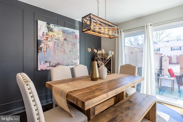 dining space with wood finished floors