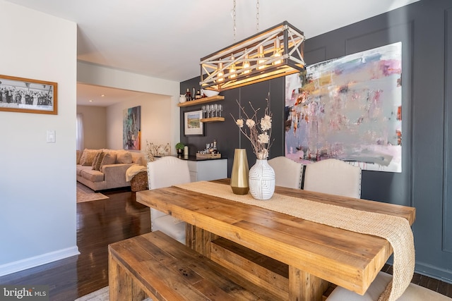 dining area featuring dark wood-style flooring and baseboards