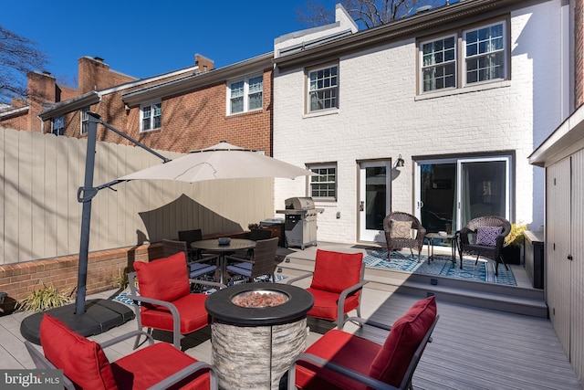 exterior space with brick siding, an outdoor living space with a fire pit, and fence