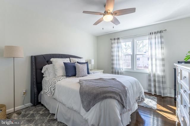 bedroom featuring ceiling fan, dark wood-type flooring, and baseboards