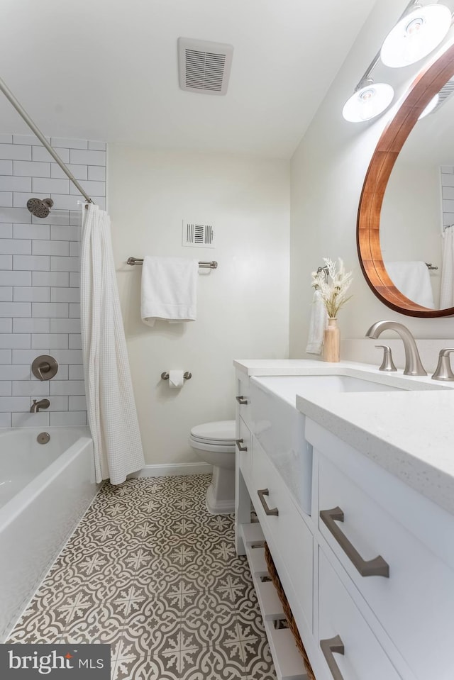 full bathroom with toilet, shower / bath combo, visible vents, and vanity