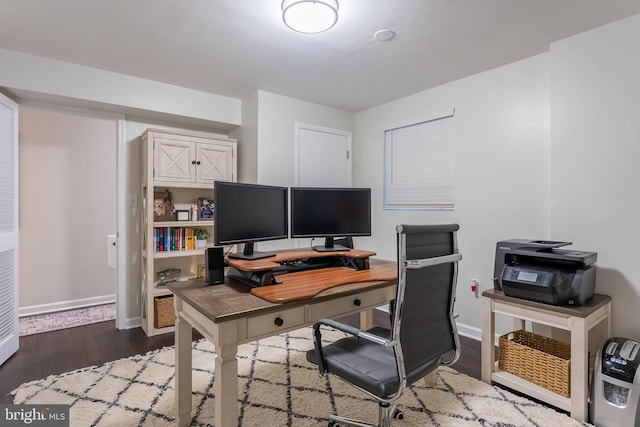 home office with baseboards and dark wood-style flooring