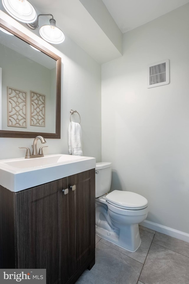 half bathroom with visible vents, baseboards, toilet, tile patterned flooring, and vanity