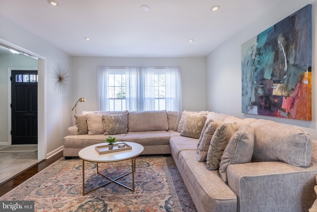 living area featuring baseboards, dark wood-style flooring, and recessed lighting