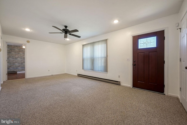 carpeted foyer entrance with ceiling fan and a baseboard radiator