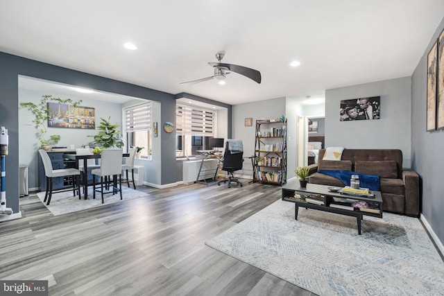 living room featuring hardwood / wood-style flooring and ceiling fan