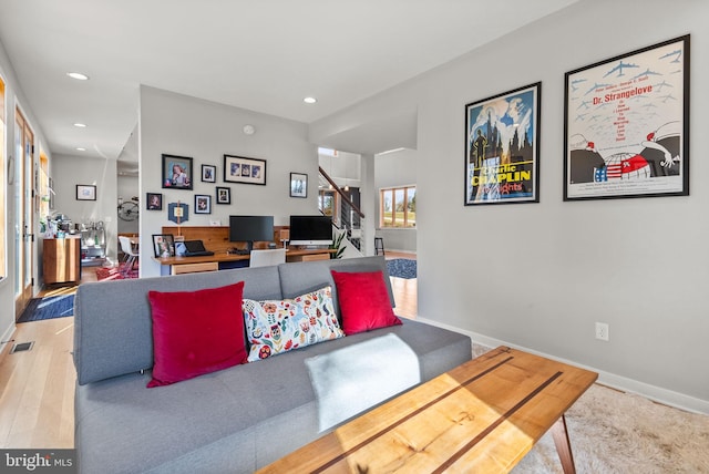 living area with stairway, wood finished floors, visible vents, baseboards, and recessed lighting