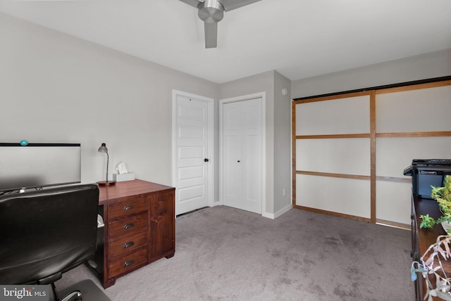 office with light carpet, baseboards, and ceiling fan