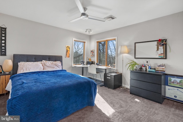 carpeted bedroom with visible vents and a ceiling fan