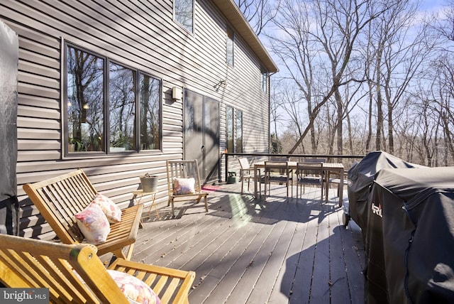 wooden terrace featuring outdoor dining space